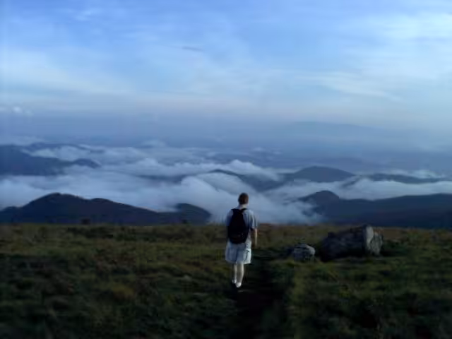 Person looking at the mountain view from Round Bald.