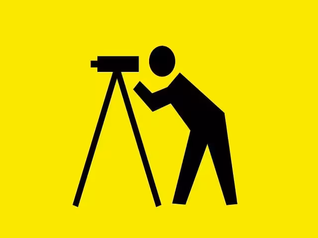 A land surveyor with a yellow background.