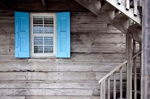 Blue shutters on a weathered house to show character.