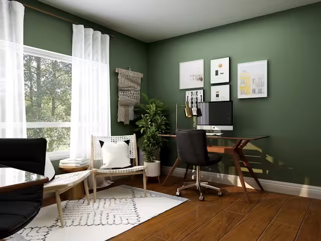A dedicated room for a home office in green.