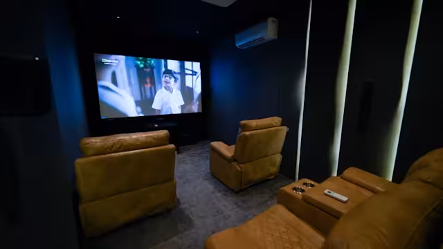A home theater with recliners in a house.