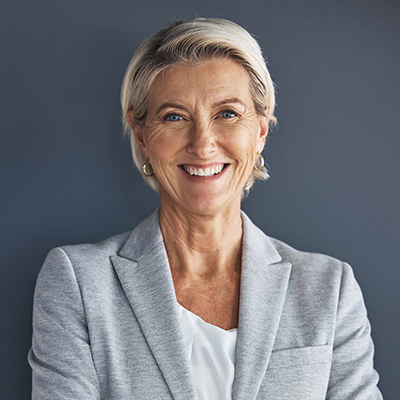 Smile, confidence and portrait of mature businesswoman with arms