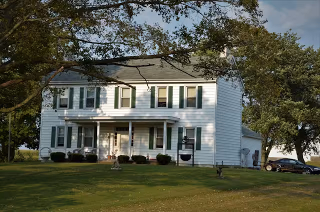 A well-built white house in the country.