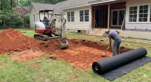 Step 1 of installation -- excavation of soil and laying the fabric.