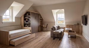 A room over a garage with space saving furniture.